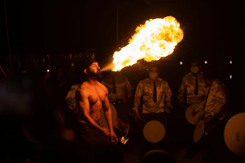 a man that is standing in front of a fire, pexels contest winner, kinetic art, revellers, kitsune holding torch, avatar image, performing