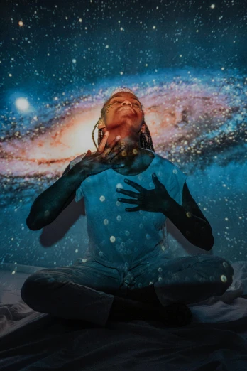 a woman sitting on a bed in front of a painting of a galaxy, trending on pexels, afrofuturism, hands shielding face, they reach into his mind, elven spirit meditating in space, intricate image