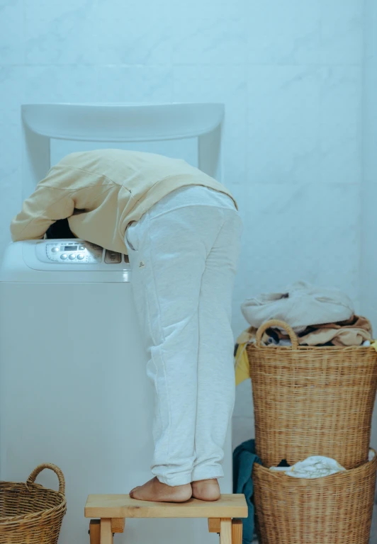 a person standing on a stool in front of a washing machine, passed out, profile image, face down, aesthetics