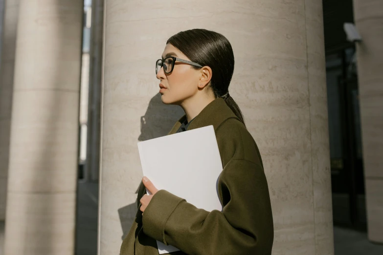 a woman in glasses holding a piece of paper, by Nina Hamnett, pexels contest winner, elegant girl in urban outfit, slicked-back hair, holding a clipboard, gemma chen