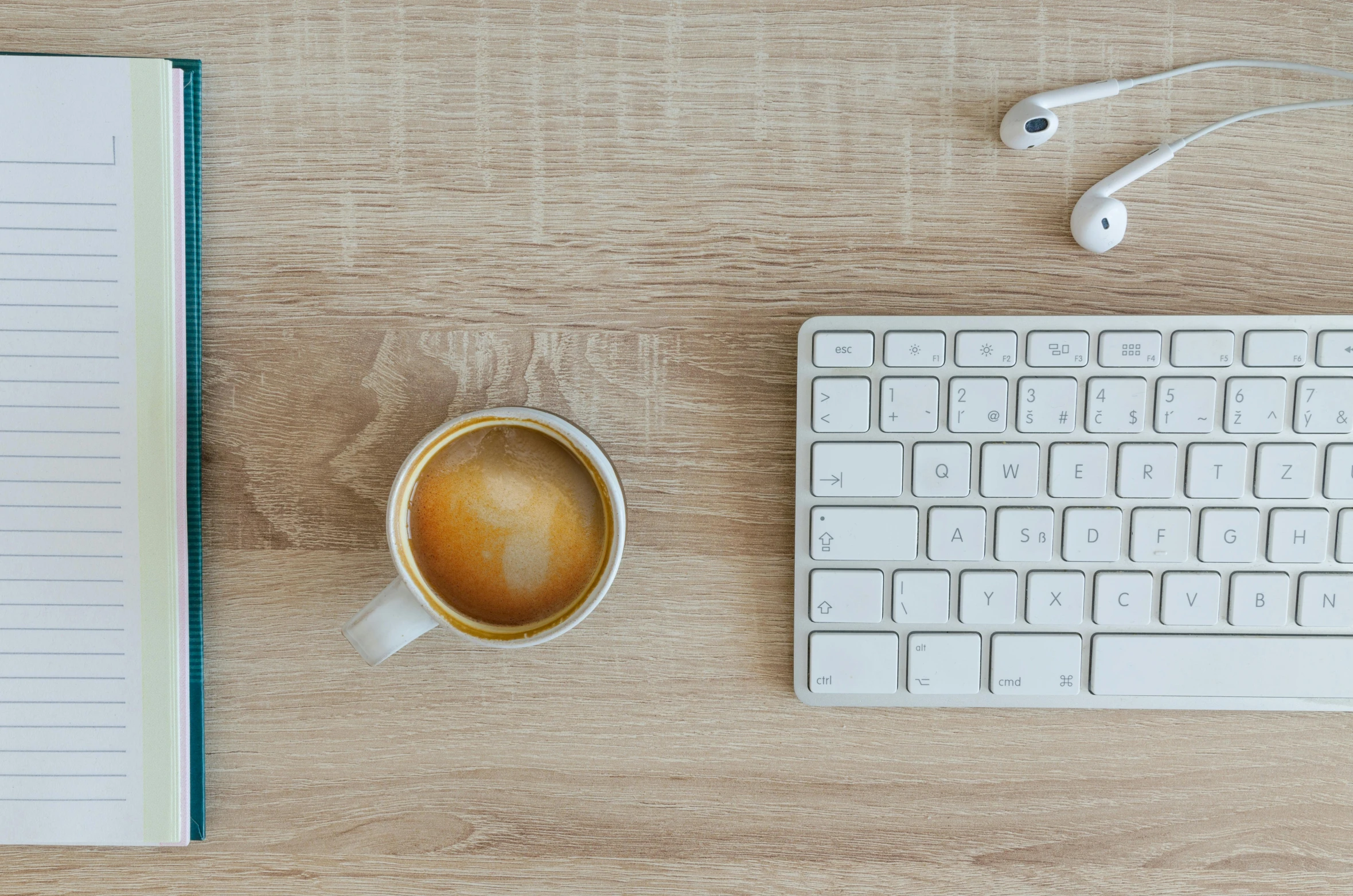 a cup of coffee next to a keyboard and headphones, trending on pexels, lacquered oak reception desk, background image, thumbnail, white