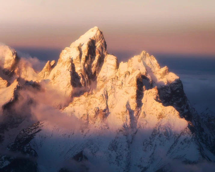 a mountain range covered in snow and clouds, an album cover, unsplash contest winner, hudson river school, pink golden hour, 8k detail post processing, majestic spires, himalayas