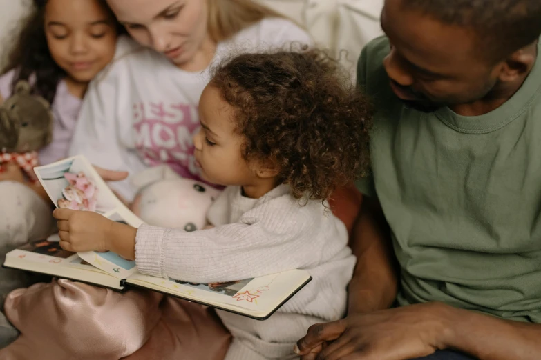 a man reading a book to a group of children, pexels contest winner, avatar image, cute photo, light skinned african young girl, jellycat