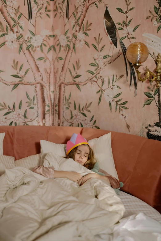 a little girl that is laying in a bed, a colorized photo, by Elsa Bleda, maximalism, wearing a party hat, cozy wallpaper, teenager hangout spot, architectural digest photo