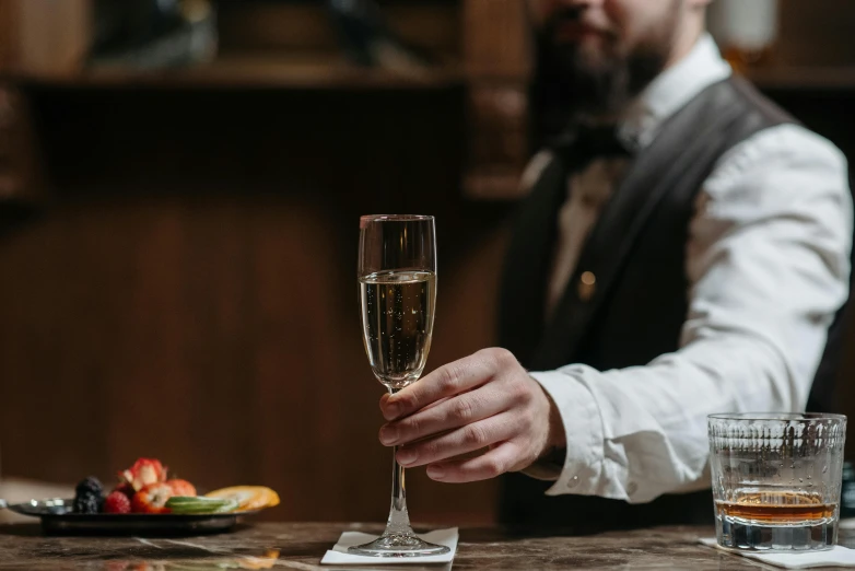 a close up of a person holding a glass of wine, champagne on the table, server in the middle, holding a baguette, gentleman's club lounge