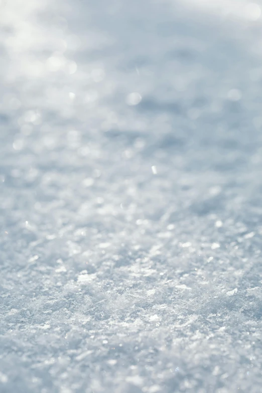 a close up of a snow covered ground, light shimmering, synthetic materials