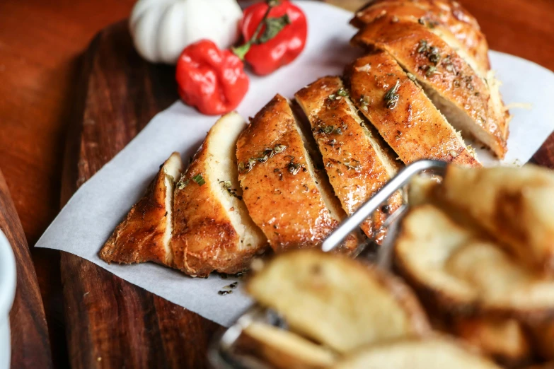 a close up of a plate of food on a table, eating garlic bread, fan favorite, chicken, profile image