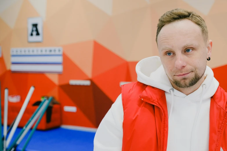a close up of a person wearing a red vest, a portrait, dim dingy gym, russian academic, avatar image, man in adidas tracksuit