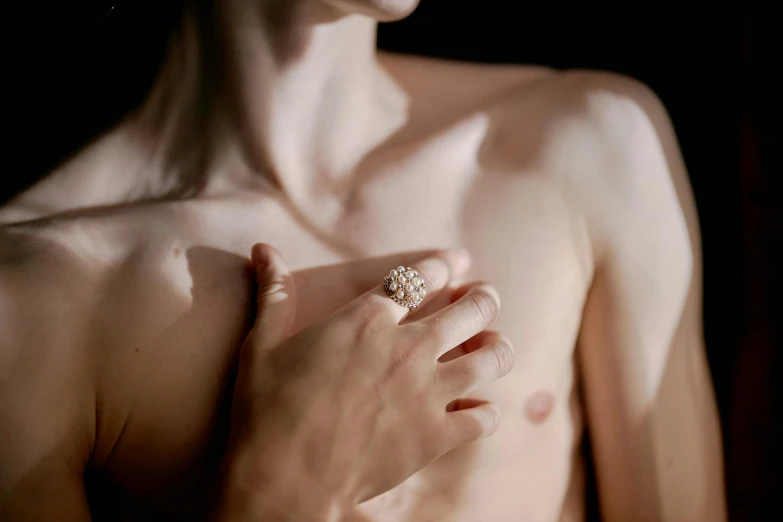 a close up of a person holding a ring, inspired by Elsa Bleda, hyperrealism, disrobed, pearls, teenage boy, fine-art photography