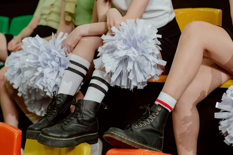 a group of young women sitting next to each other, trending on pexels, antipodeans, wearing skirt and high socks, paper chrysanthemums, football, punk party