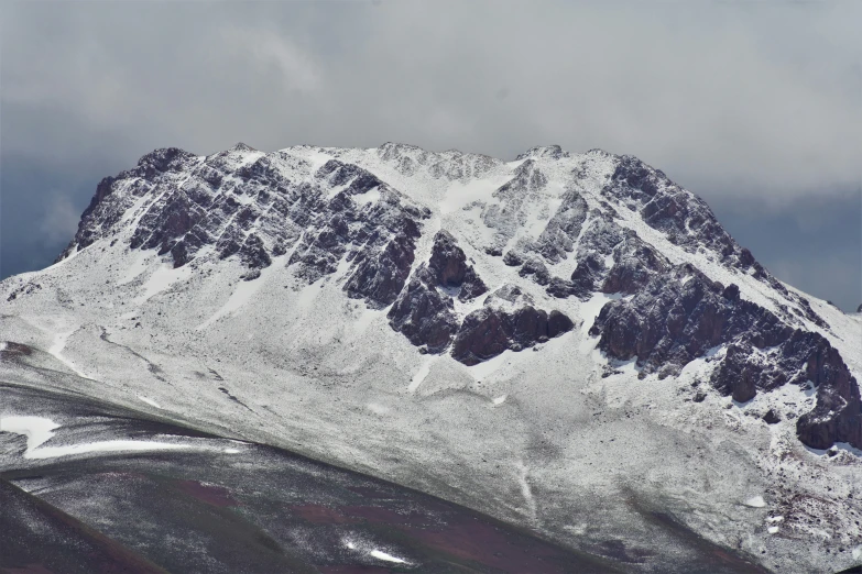 a snow covered mountain on a cloudy day, an album cover, by Muggur, pexels contest winner, hurufiyya, a beautiful mine, brown, photos, snowy craggy sharp mountains