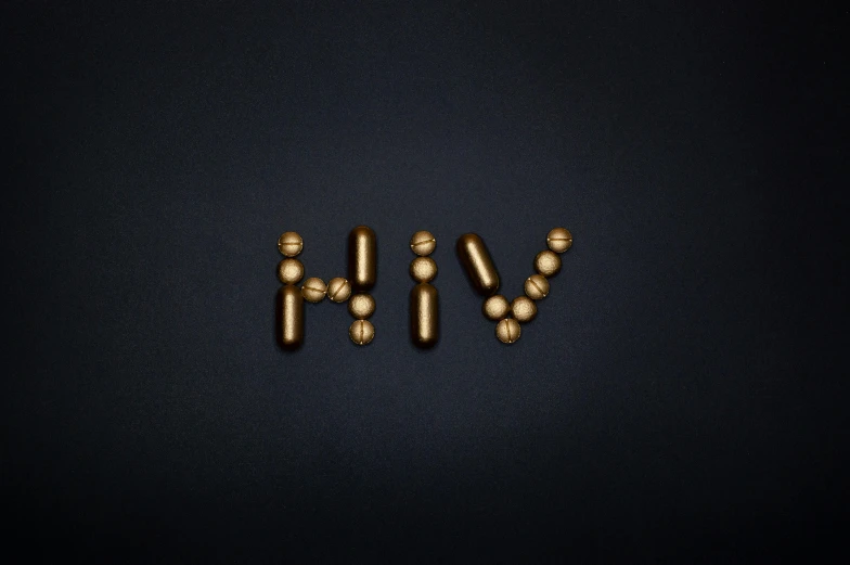 gold pills forming the word hh on a black background, by Attila Meszlenyi, trending on pexels, graffiti, lgbt, ant, nursing, style of the game rimworld