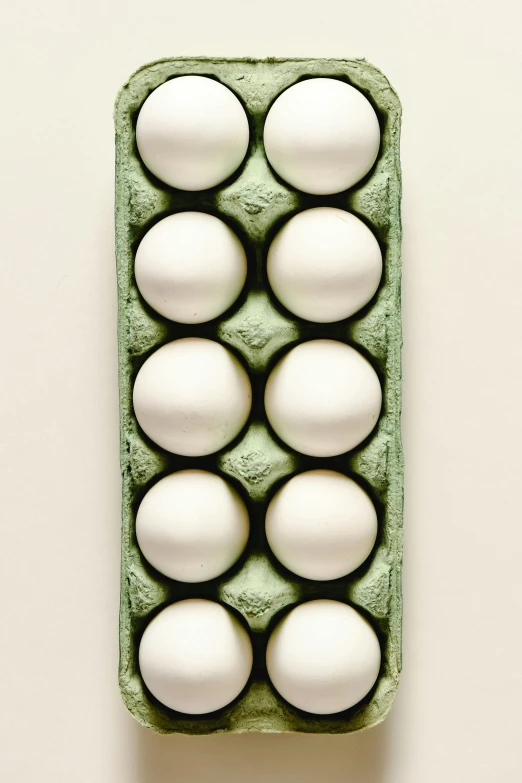 a carton of eggs sitting on top of a table, by Ben Zoeller, high angle, ignant, caucasian, mint