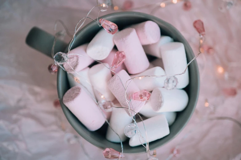 a cup filled with marshmallows on top of a table, by Sylvia Wishart, pexels contest winner, aestheticism, pink arches, string lights, 15081959 21121991 01012000 4k, close up of single sugar crystal