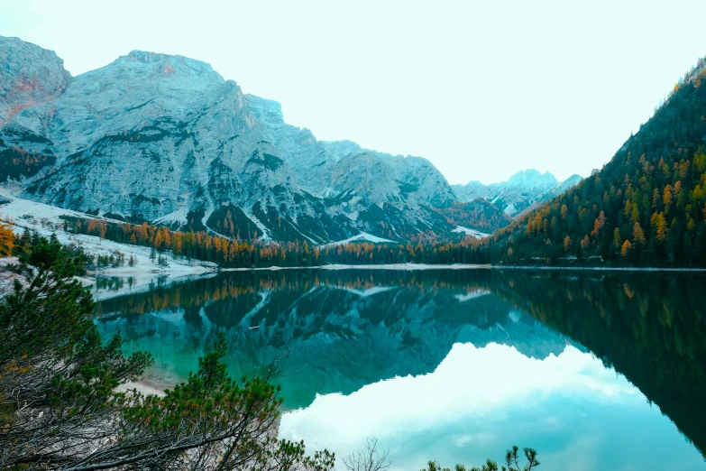 a lake with a mountain in the background, by Emma Andijewska, pexels contest winner, teal aesthetic, mirrored, italian masterpiece, slightly pixelated