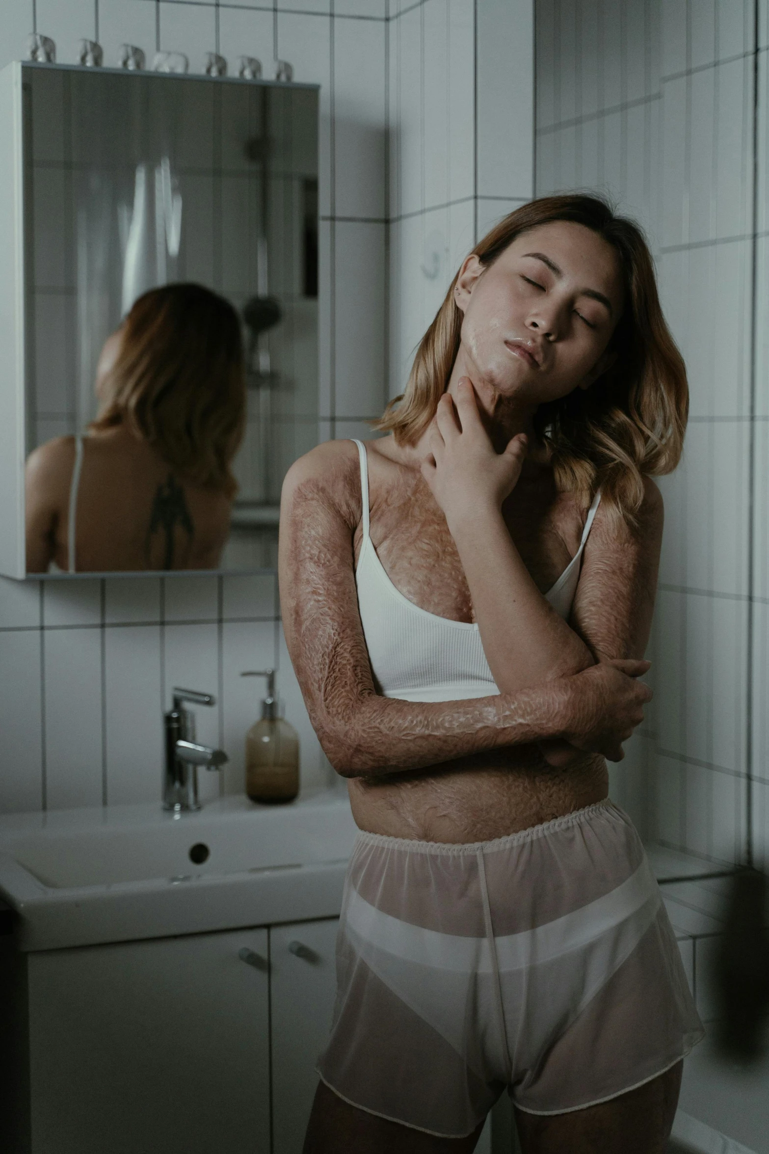 a woman standing in front of a mirror in a bathroom, a hyperrealistic painting, inspired by Elsa Bleda, trending on pexels, stomach skin, covered in white flour, photo of slim girl, dirty