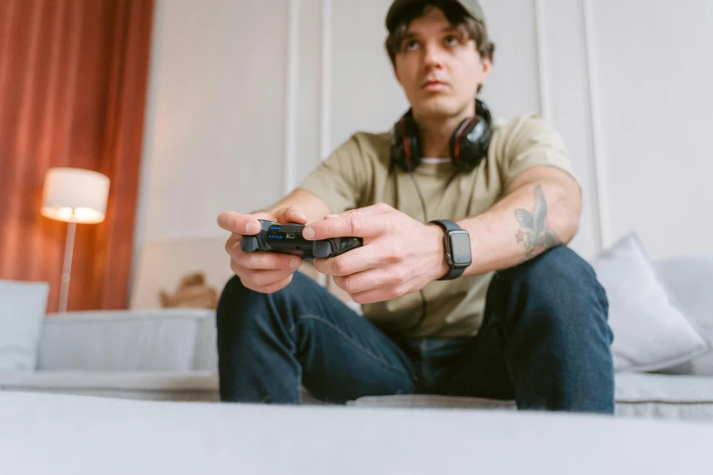 a man sitting on a bed holding a video game controller, pexels, hyperrealism, avatar image, taken with canon 5d mk4, sitting in a lounge, professional picture