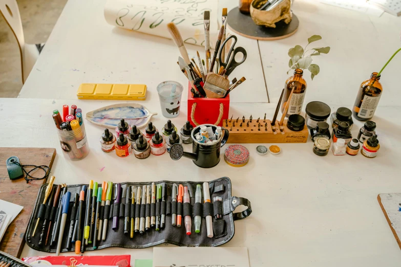 a white table topped with lots of art supplies, by Daniel Lieske, pexels contest winner, fan favorite, caligraphy, workbench, arbeitsrat fur kunst