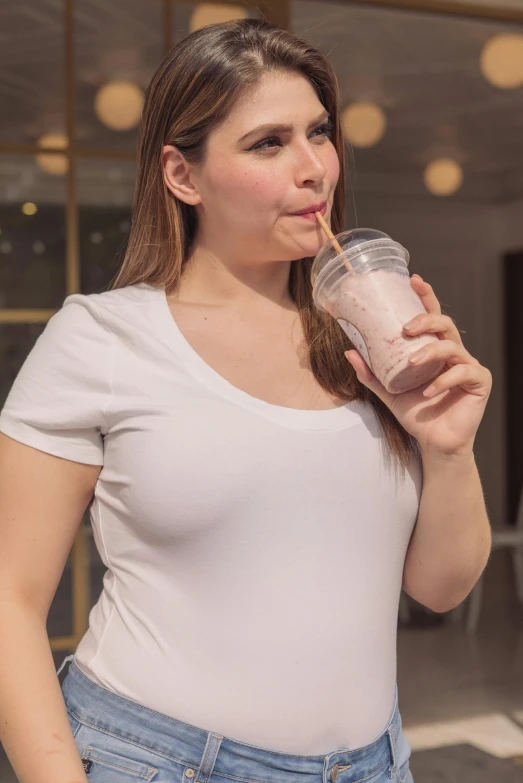 a woman in a white shirt is drinking a smoothie, by John Luke, pregnant belly, zoomed out full body, silicone skin, wearing tanktop