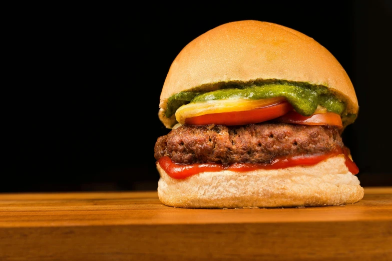 a hamburger sitting on top of a wooden table, profile image, epicurious, uncrop, an olive skinned