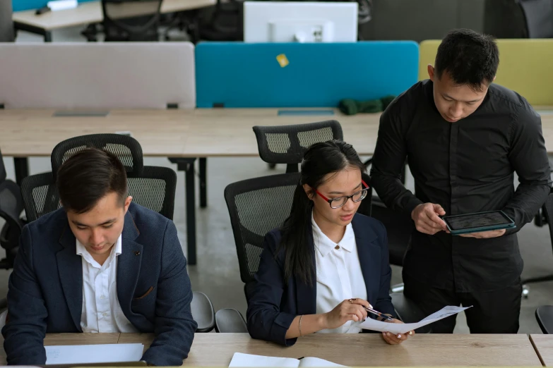 a group of people sitting around a wooden table, sitting at a computer desk, darren quach, avatar image, maintenance photo