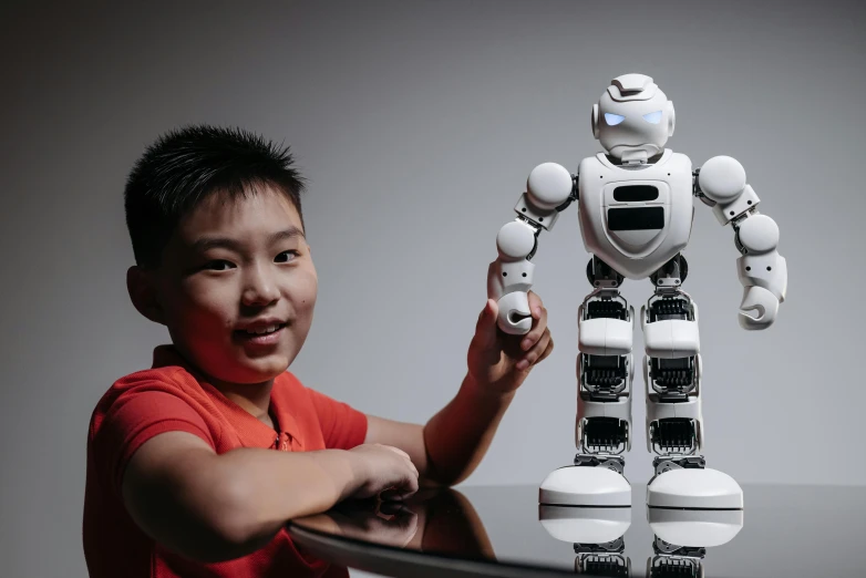 a little boy that is standing next to a robot, inspired by Jason Teraoka, pexels contest winner, holding an epée, bao pham, algorithm, studio photo