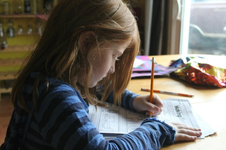 a little girl sitting at a table with a pencil in her hand, by Alison Watt, pexels contest winner, 15081959 21121991 01012000 4k, studying, thumbnail, a girl with blonde hair