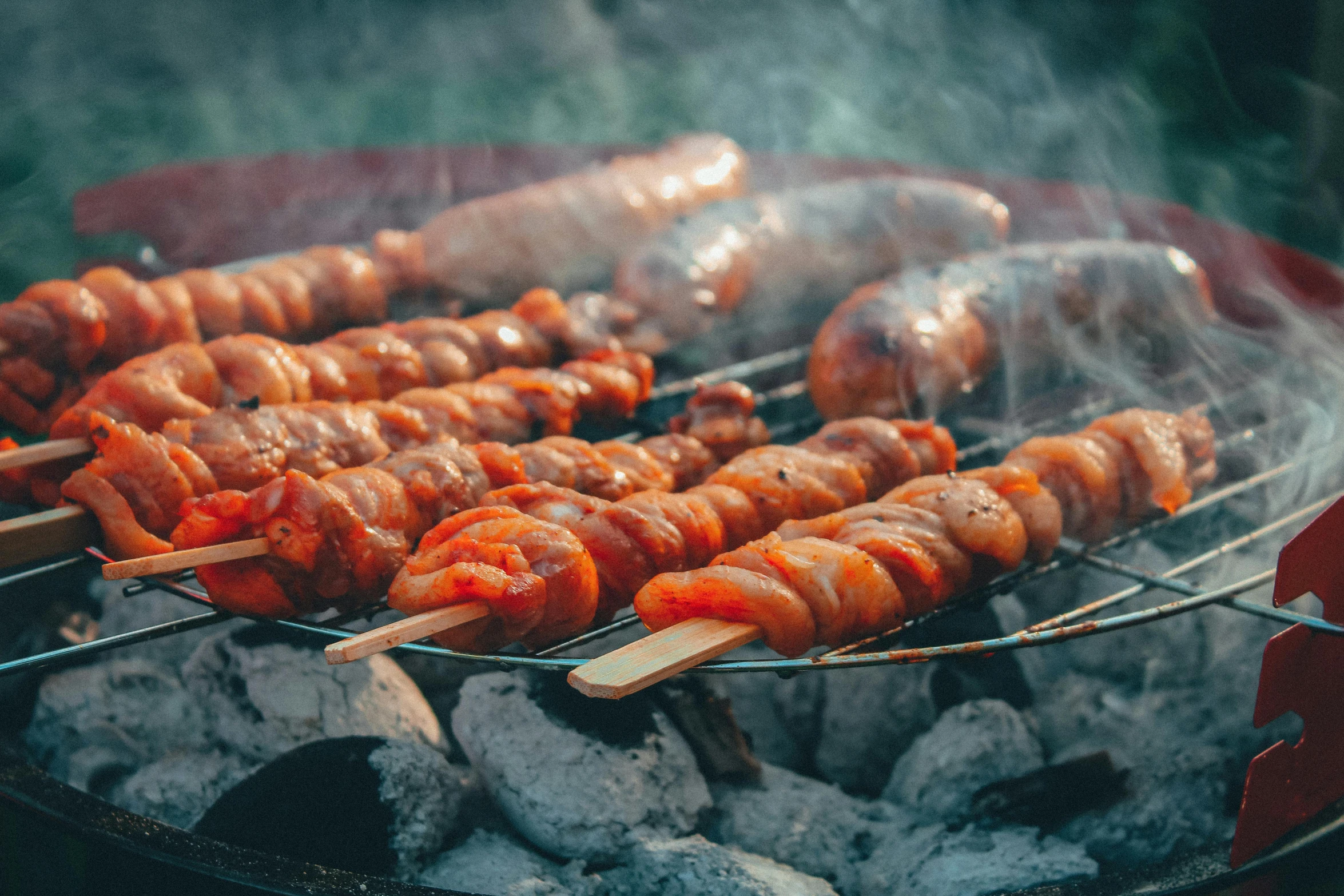 a close up of skewered meat on a grill, by Adam Marczyński, pexels contest winner, with some sausages on the fire, hotdogs, 6 pack, thumbnail