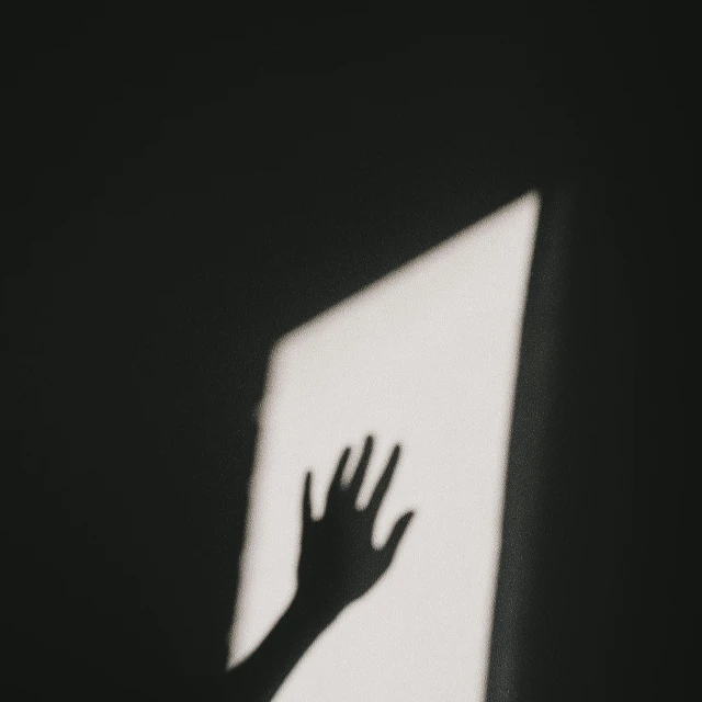 a shadow of a hand reaching out of a window, by Elsa Bleda, pexels contest winner, conceptual art, white moon and black background, horror wallpaper aesthetic, instagram post, paper cut out