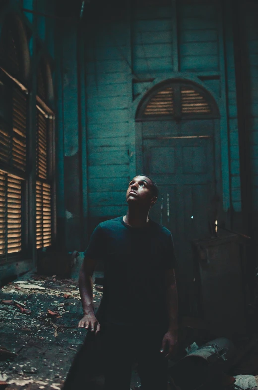 a man in a black shirt standing in a dark room, pexels contest winner, renaissance, : kendrick lamar, in a desolate abandoned house, standing in a church, promotional image