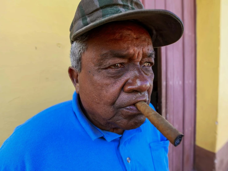 a man in a hat smokes a cigar, a portrait, pexels contest winner, aboriginal capirote, cuban setting, profile image, grumpy [ old ]