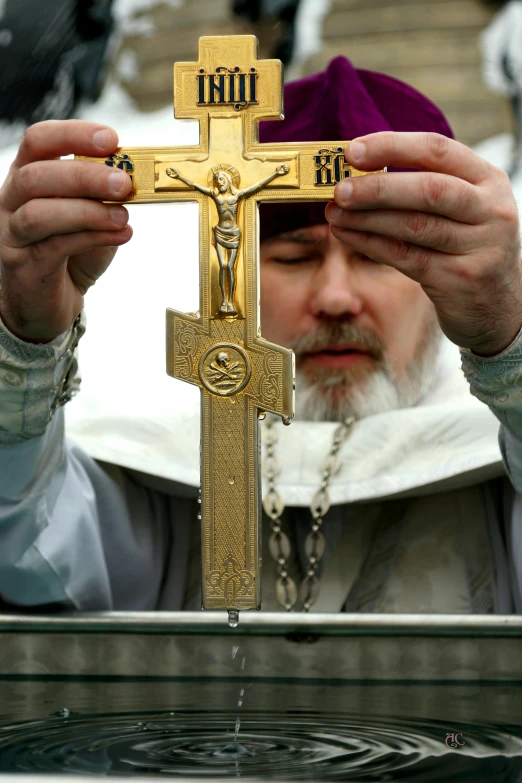 a close up of a person holding a cross, andrei riabovitchevy, inauguration, ap news photograph, beautiful gold saint