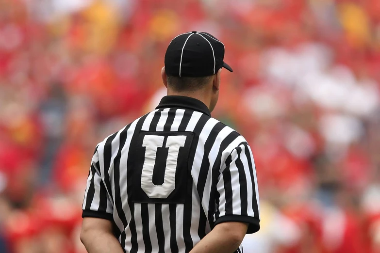 a referee wearing a black and white striped shirt, unsplash, hurufiyya, reuters, nfl, iu, 2263539546]