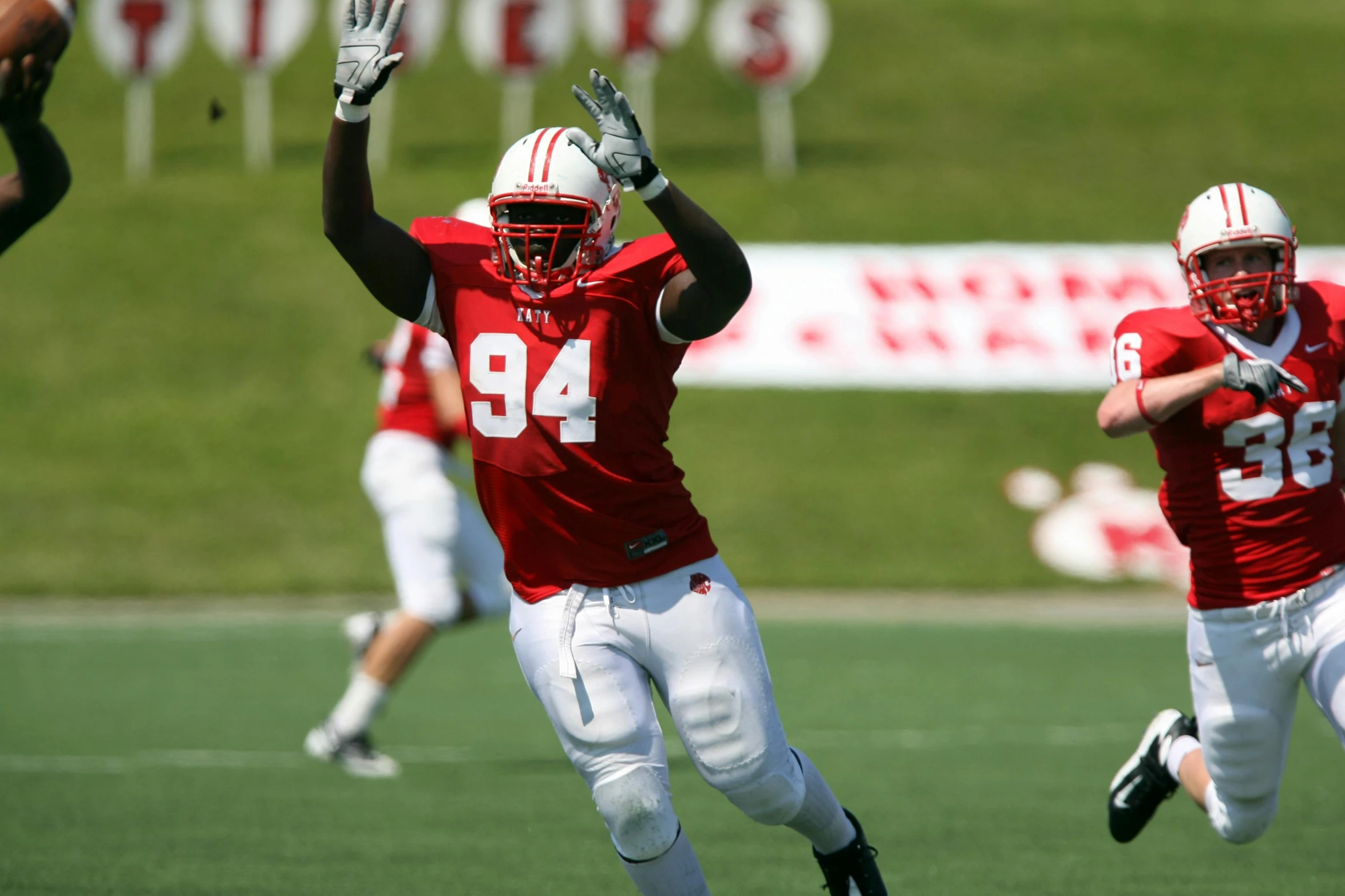 a group of young men playing a game of football, a digital rendering, by Everett Warner, unsplash, happening, white and red body armor, wisconsin, waving, malcolm hart