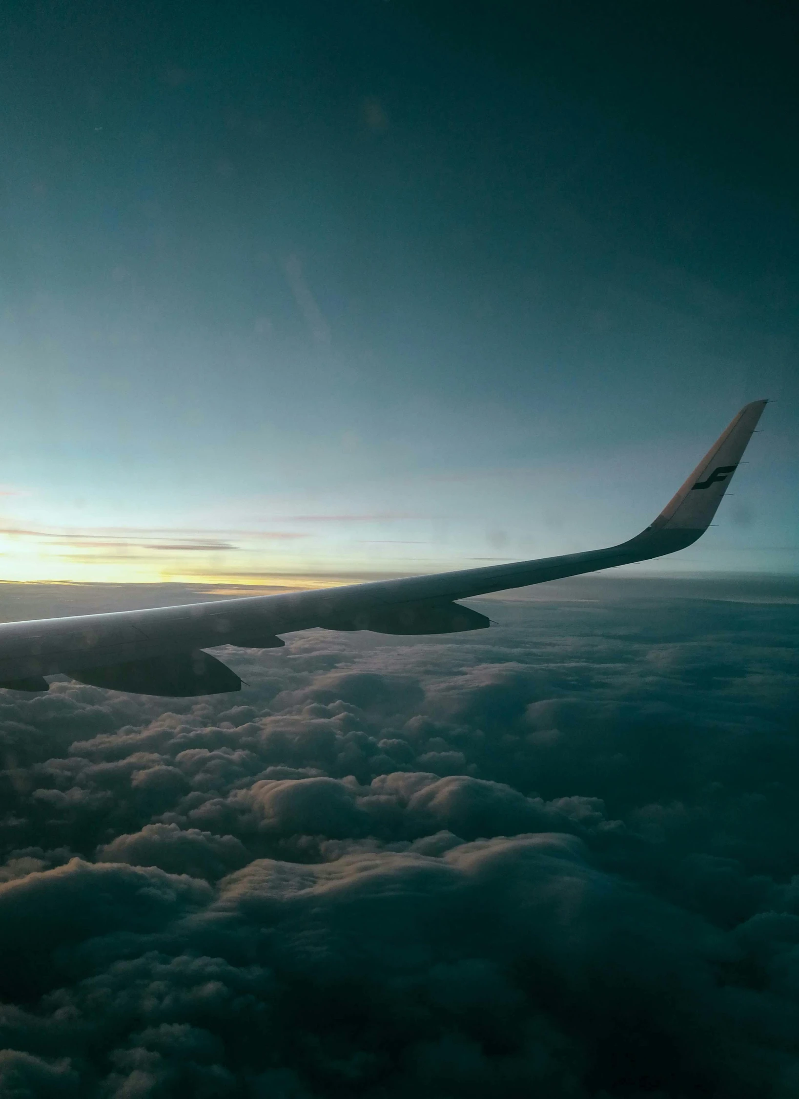 the wing of an airplane flying above the clouds, by Christen Dalsgaard, pexels contest winner, hurufiyya, avatar image, profile picture, in the evening, perfect shape