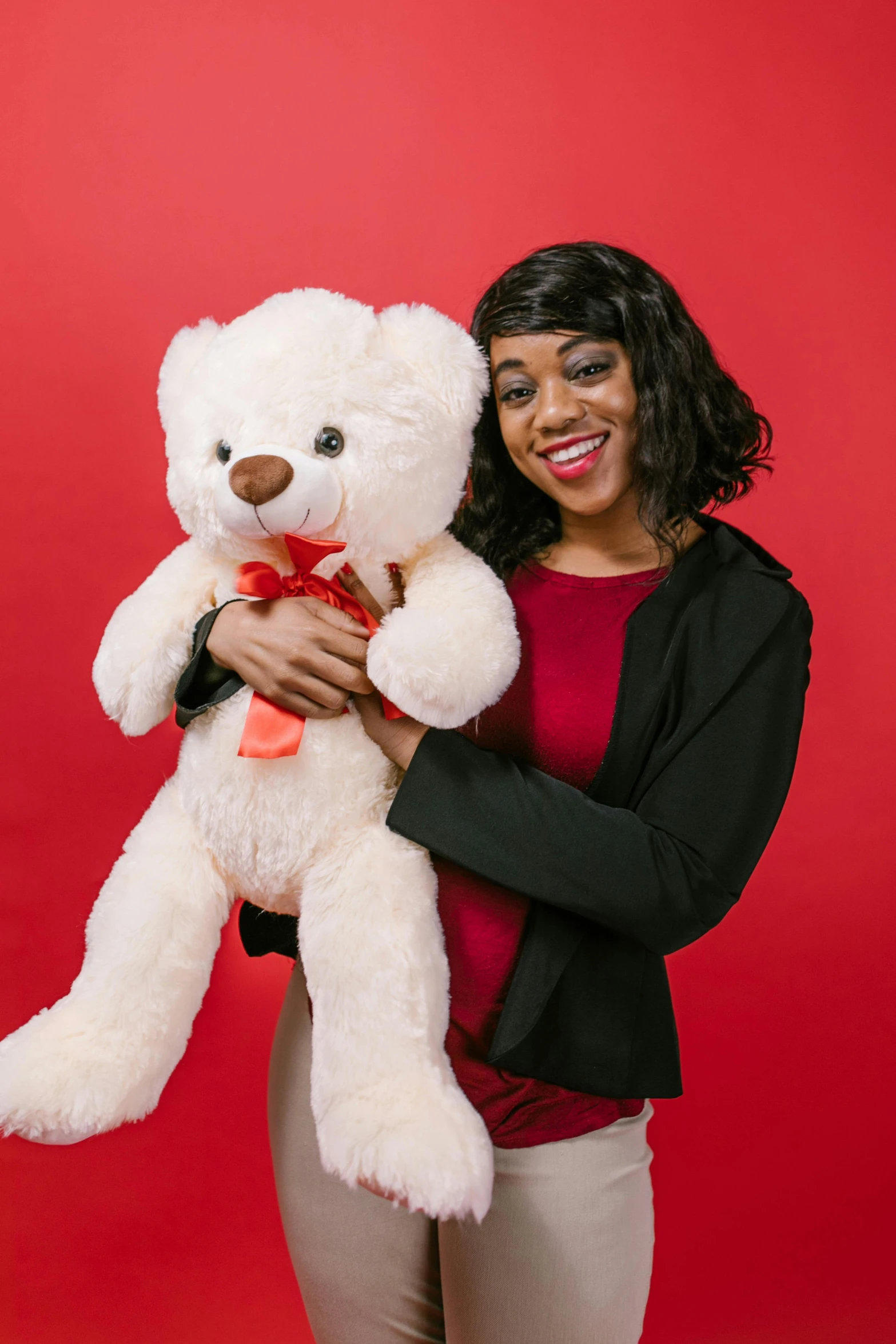 a woman holding a white teddy bear on a red background, youthful taliyah, slide show, with a white background, product shot