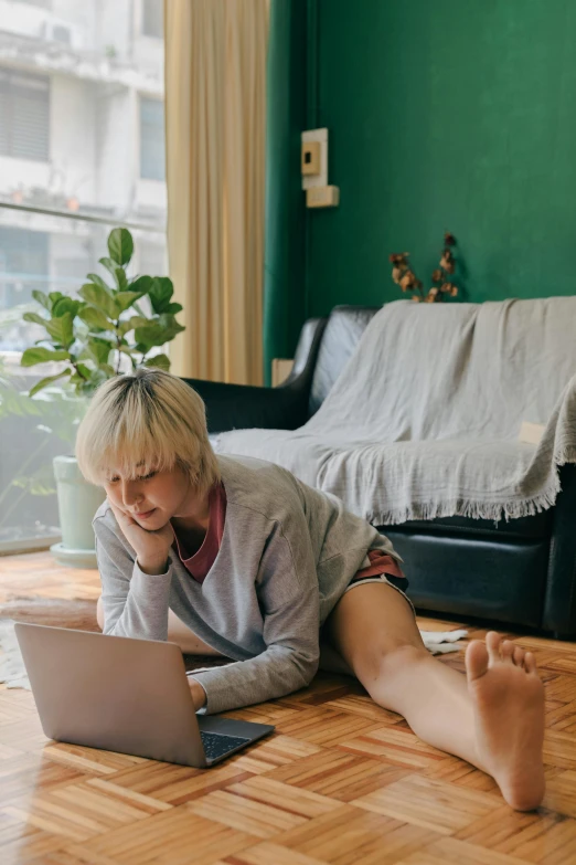 a woman laying on the floor using a laptop, pexels contest winner, teenage boy, living room vibe, full body sarcastic pose, joy ang