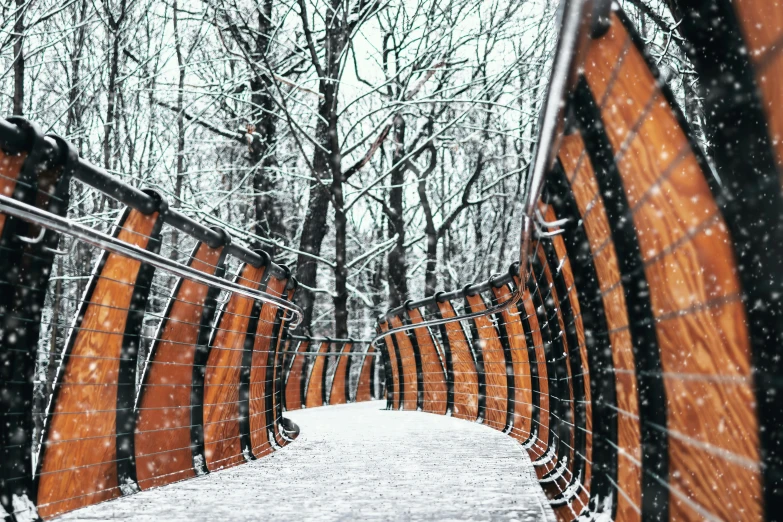 a wooden bench sitting in the middle of a snow covered park, by Adam Marczyński, pexels contest winner, graffiti, curved bridge, gray and orange colours, viewed from below, multiple stories