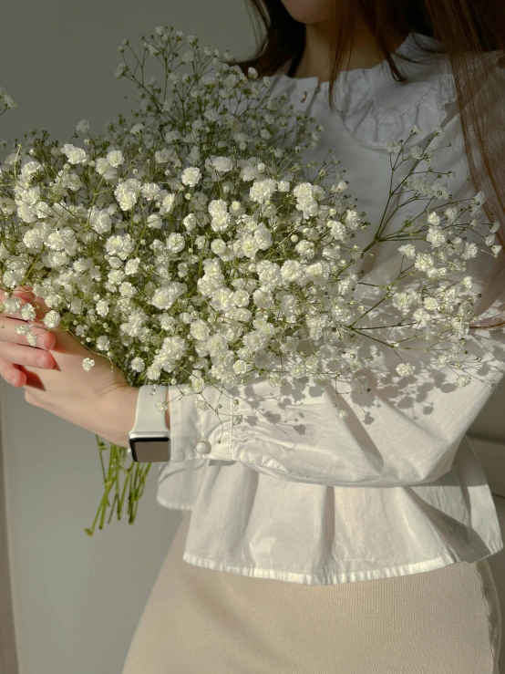 a woman holding a bunch of white flowers, inspired by Elsa Bleda, cropped wide sleeve, white wrinkled shirt, jinyoung shin, 4k)