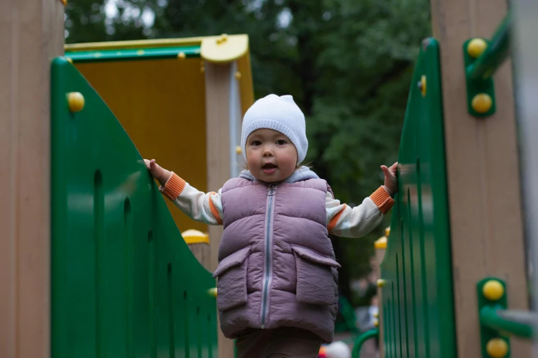 a small child standing at the top of a slide, pexels contest winner, sofya emelenko, standing astride a gate, panels, 15081959 21121991 01012000 4k