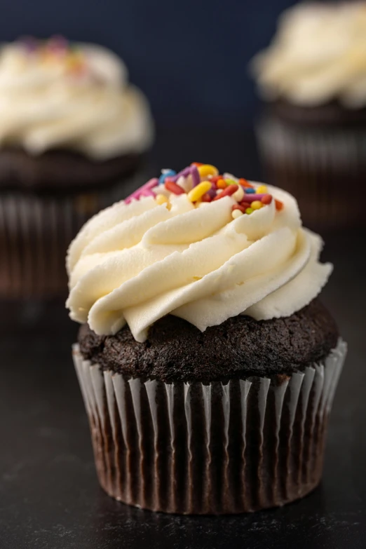 three chocolate cupcakes with white frosting and sprinkles, daily specials, profile, highly upvoted, basic