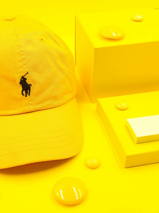 a yellow hat sitting on top of a table, inspired by Ralph Earl, unsplash contest winner, gamer aesthetic, 🦩🪐🐞👩🏻🦳, 2 k aesthetic, yellow wallpaper