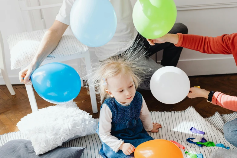 a little girl sitting on the floor with a bunch of balloons, pexels contest winner, caring fatherly wide forehead, electrostatic hum, on a white table, profile image
