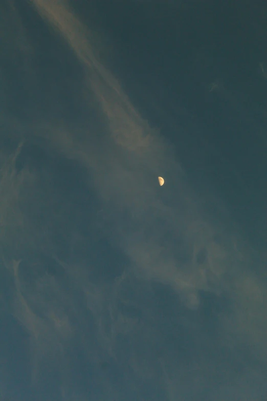 a plane flying in the sky with the moon in the background, a picture, by Russell Chatham, nasa true color photograph, smoke :6, zoomed out to show entire image, partly cloudy day