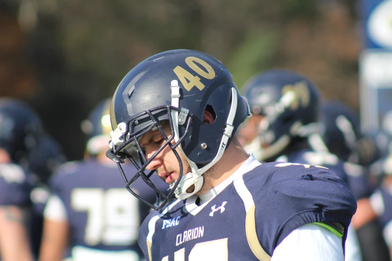 a close up of a football player wearing a helmet, by Ben Thompson, navy, slightly sunny weather, cleary see face, unedited