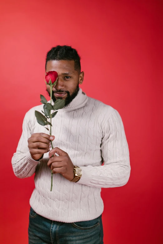 a man holding a rose in front of his face, an album cover, pexels contest winner, romanticism, mkbhd, red sweater and gray pants, bearded man, flirty