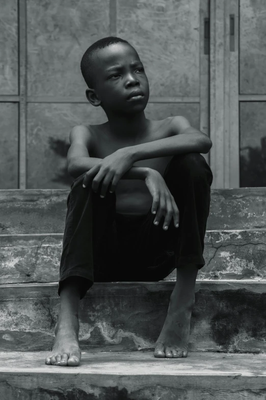 a young boy sitting on the steps of a building, a black and white photo, by Chinwe Chukwuogo-Roy, pexels contest winner, man is with black skin, boy thin face, sittin, album art