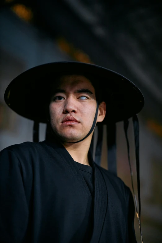 a close up of a person wearing a hat, inspired by Ma Shi, reddit, wearing black robes, paul kwon, full frame shot, high quality photo