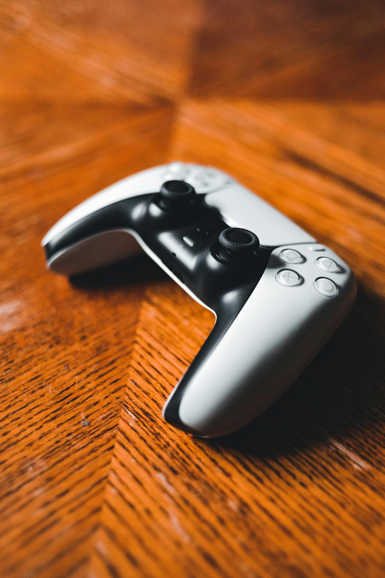 a video game controller sitting on top of a wooden table, by Dan Content, ps 5, instagram post, stockphoto, 1/60