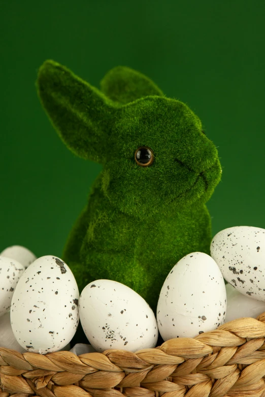 a stuffed rabbit sitting in a basket filled with eggs, a digital rendering, by Alison Geissler, shutterstock contest winner, lush green, closeup shot of face, product display photograph, 2070